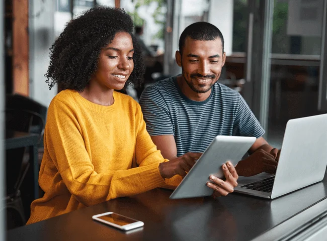 Young-couple-using-digital-tablet-in-cafe.png